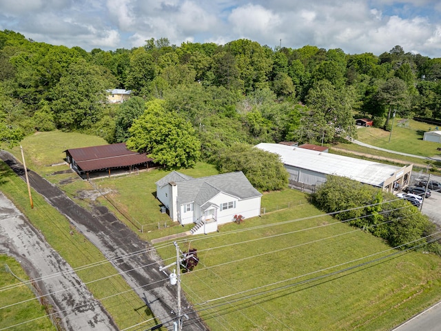 view of subject property with a forest