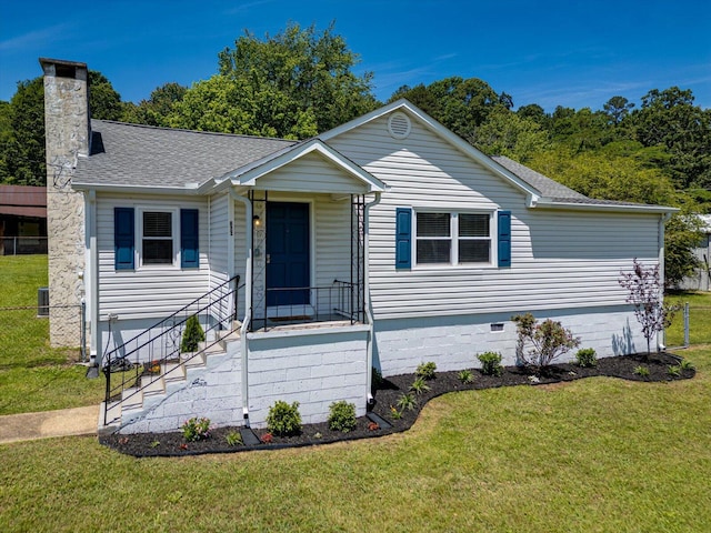 view of front of home with a front yard, roof with shingles, a chimney, and crawl space