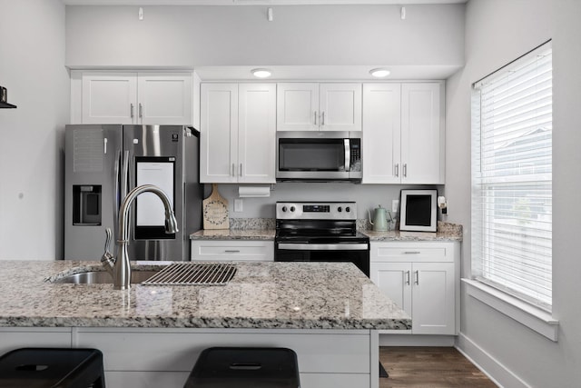 116 Paxtons Way, Ringgold, GA 30736 - kitchen featuring stainless steel appliances, white cabinets, dark wood-style floors, and light stone counters