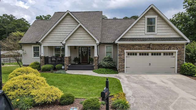 536 Clintons Pass NW, Cleveland, TN 37312 - craftsman-style home with a porch, concrete driveway, a front yard, stone siding, and roof with shingles
