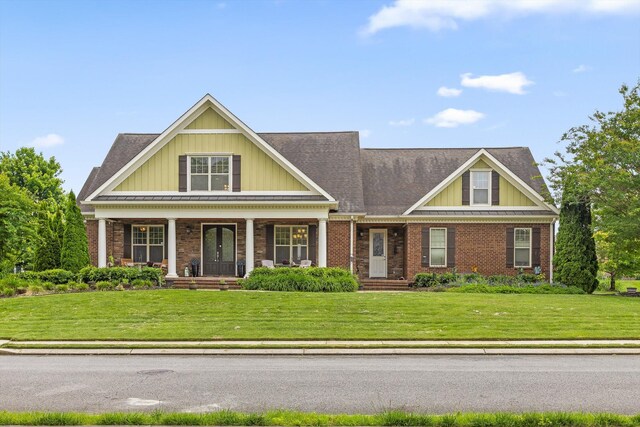 8109 Propeller Dr, Ooltewah, TN 37363 - craftsman house featuring a front yard, board and batten siding, brick siding, and a porch