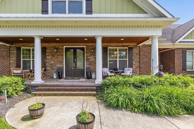 8109 Propeller Dr, Ooltewah, TN 37363 - entrance to property with covered porch, board and batten siding, and stone siding