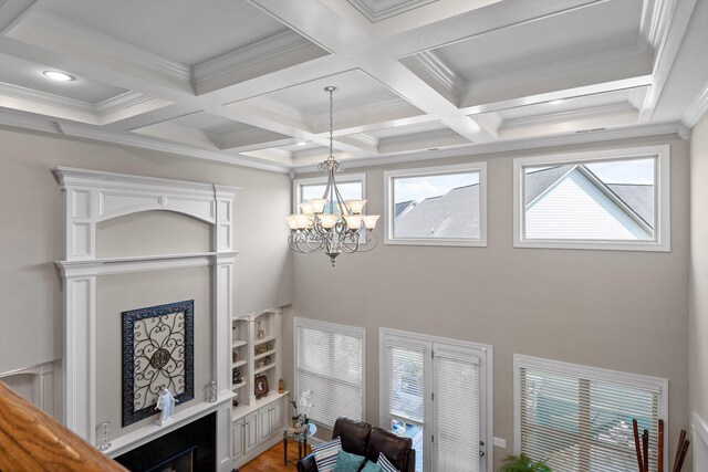 8109 Propeller Dr, Ooltewah, TN 37363 - living area featuring beam ceiling, a chandelier, wood finished floors, coffered ceiling, and ornamental molding