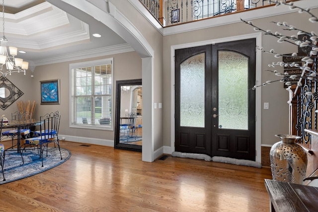 8109 Propeller Dr, Ooltewah, TN 37363 - foyer entrance with arched walkways, french doors, a chandelier, wood finished floors, and crown molding
