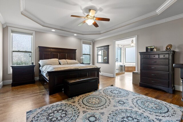 8109 Propeller Dr, Ooltewah, TN 37363 - bedroom featuring a tray ceiling, multiple windows, wood finished floors, baseboards, and ornamental molding