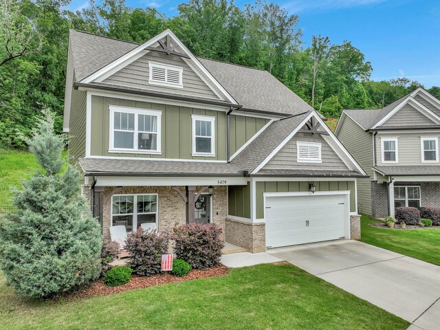5479 Amber Grove Way, Hixson, TN 37343 - craftsman inspired home with board and batten siding, a shingled roof, a front yard, an attached garage, and concrete driveway