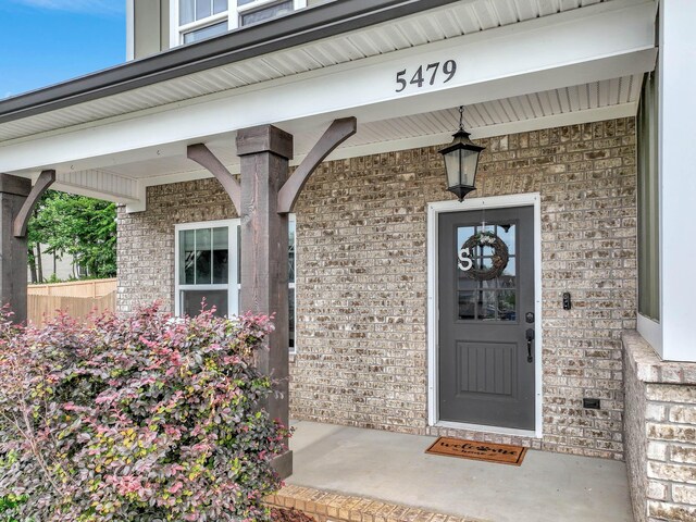 5479 Amber Grove Way, Hixson, TN 37343 - view of exterior entry featuring brick siding and a porch