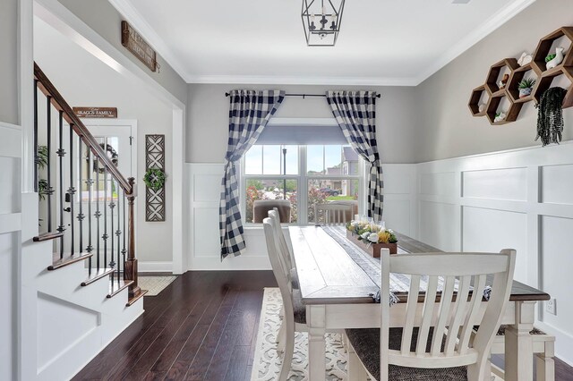 5479 Amber Grove Way, Hixson, TN 37343 - dining space featuring a decorative wall, dark wood-style floors, crown molding, a wainscoted wall, and stairway