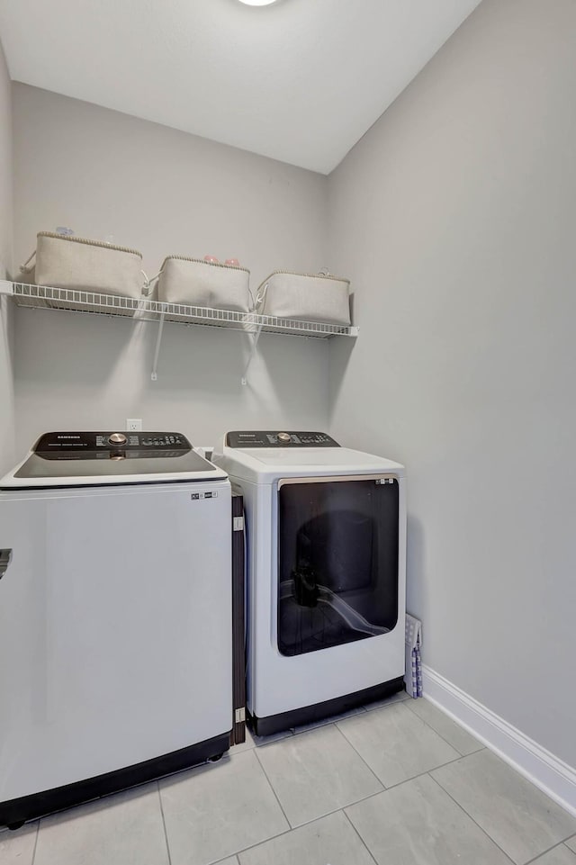 5479 Amber Grove Way, Hixson, TN 37343 - laundry area featuring washer and clothes dryer, baseboards, and light tile patterned floors