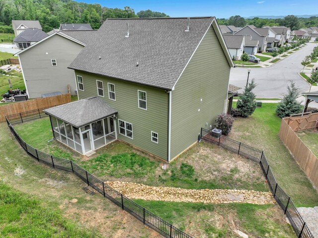 5479 Amber Grove Way, Hixson, TN 37343 - back of property featuring a sunroom, a residential view, roof with shingles, and cooling unit