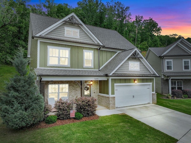 5479 Amber Grove Way, Hixson, TN 37343 - craftsman-style home featuring board and batten siding, an attached garage, driveway, a front lawn, and roof with shingles