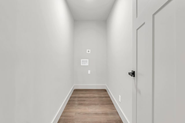 laundry area featuring electric dryer hookup, wood finished floors, baseboards, and washer hookup
