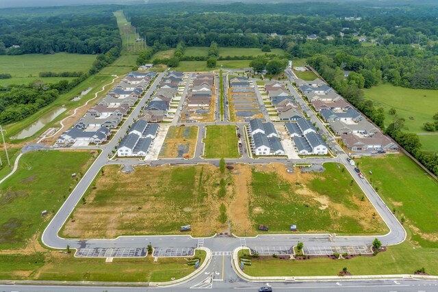 aerial view of property and surrounding area featuring nearby suburban area
