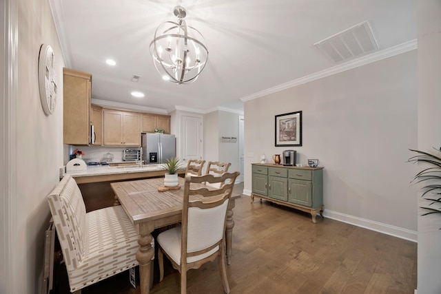 dining room featuring a chandelier, ornamental molding, wood finished floors, baseboards, and recessed lighting