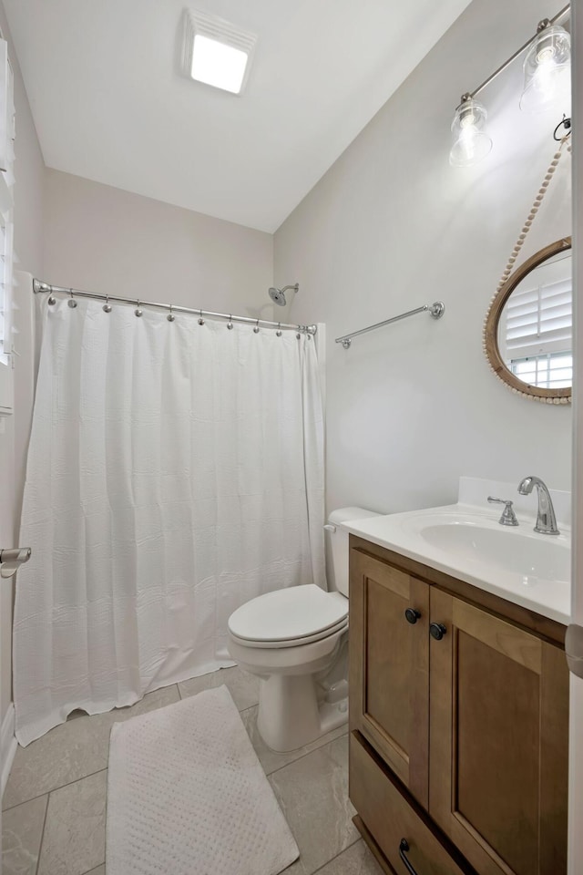 bathroom featuring toilet, tile patterned flooring, vanity, and a shower with curtain