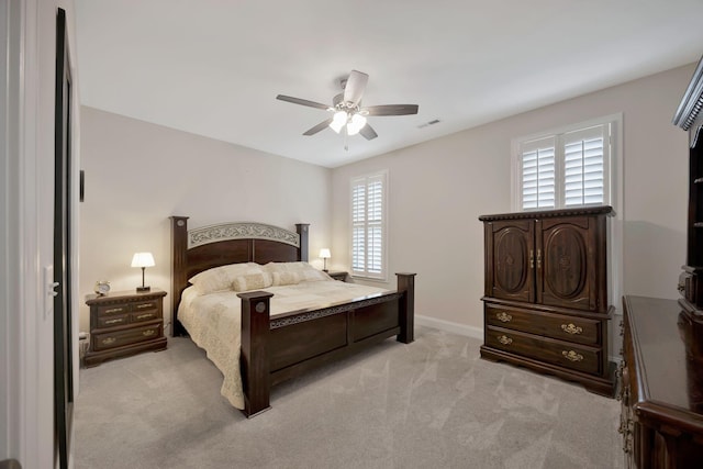bedroom with light carpet, a ceiling fan, and baseboards