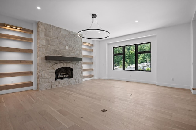 1608 Knickerbocker Ave, Chattanooga, TN 37405 - unfurnished living room with wood finished floors, a stone fireplace, baseboards, built in features, and recessed lighting