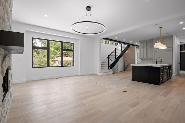 1608 Knickerbocker Ave, Chattanooga, TN 37405 - kitchen featuring light countertops, baseboards, light wood-style floors, an island with sink, and open floor plan