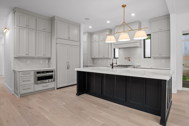 1608 Knickerbocker Ave, Chattanooga, TN 37405 - kitchen featuring oven, backsplash, a sink, a center island with sink, and paneled built in fridge