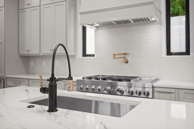 1608 Knickerbocker Ave, Chattanooga, TN 37405 - kitchen with tasteful backsplash, custom range hood, a sink, and light stone countertops