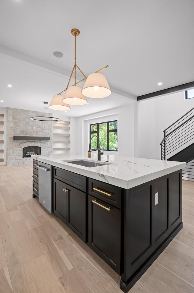 1608 Knickerbocker Ave, Chattanooga, TN 37405 - kitchen featuring a sink, dishwasher, dark cabinets, open floor plan, and light wood-type flooring