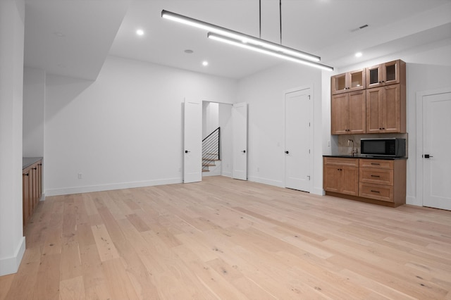 1608 Knickerbocker Ave, Chattanooga, TN 37405 - unfurnished living room with light wood finished floors, stairway, a sink, recessed lighting, and baseboards