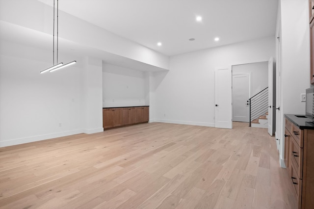 1608 Knickerbocker Ave, Chattanooga, TN 37405 - unfurnished living room with light wood-type flooring, stairway, recessed lighting, and baseboards