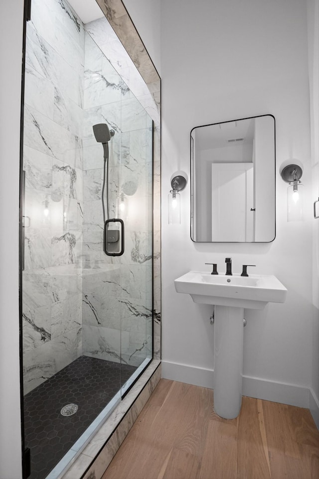 1608 Knickerbocker Ave, Chattanooga, TN 37405 - bathroom featuring a marble finish shower, baseboards, and wood finished floors