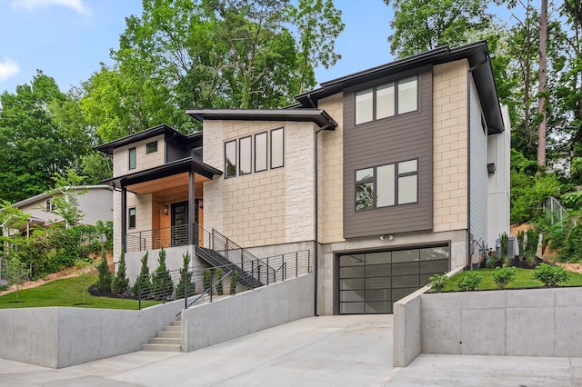 1608 Knickerbocker Ave, Chattanooga, TN 37405 - contemporary house featuring an attached garage, driveway, stone siding, and stairway