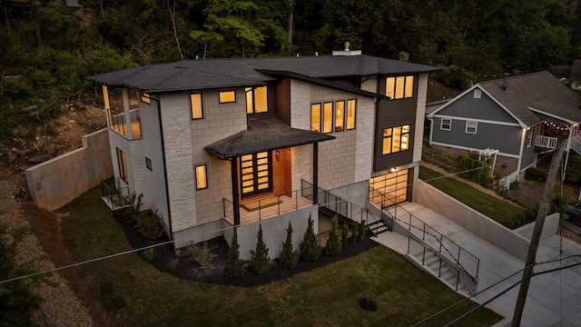 1608 Knickerbocker Ave, Chattanooga, TN 37405 - view of front facade with concrete driveway, a garage, stairway, a shingled roof, and a balcony