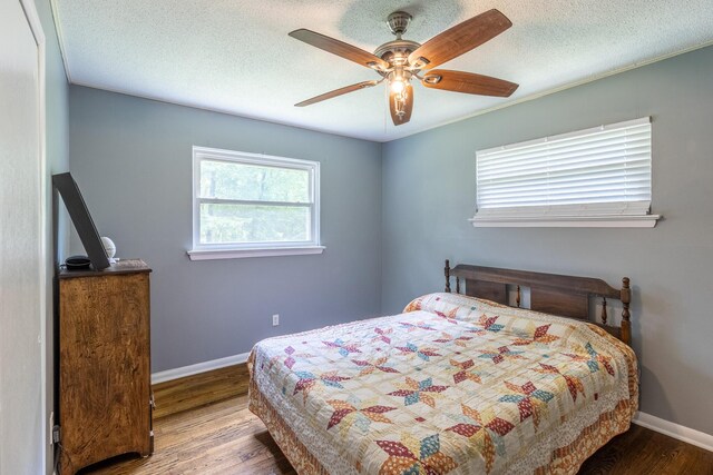 2524 Lyons Ln, Soddy Daisy, TN 37379 - bedroom with wood finished floors, baseboards, a ceiling fan, and a textured ceiling