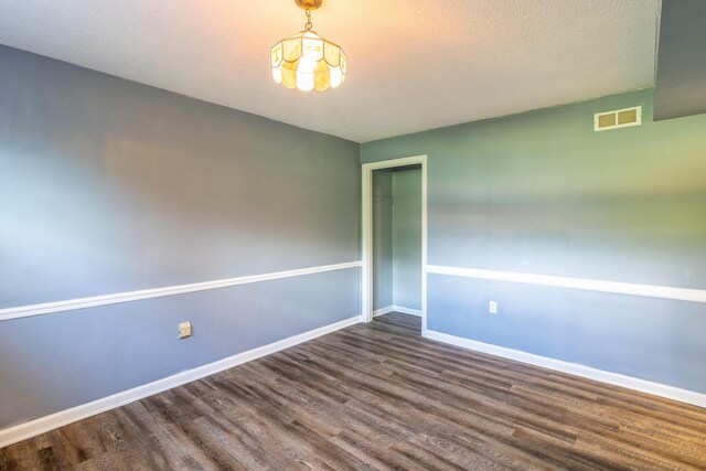2524 Lyons Ln, Soddy Daisy, TN 37379 - empty room with wood finished floors, baseboards, and a chandelier