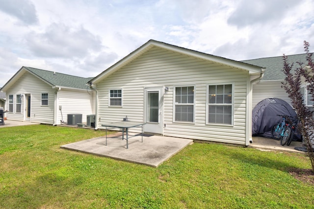 back of property with a patio area, a lawn, and cooling unit