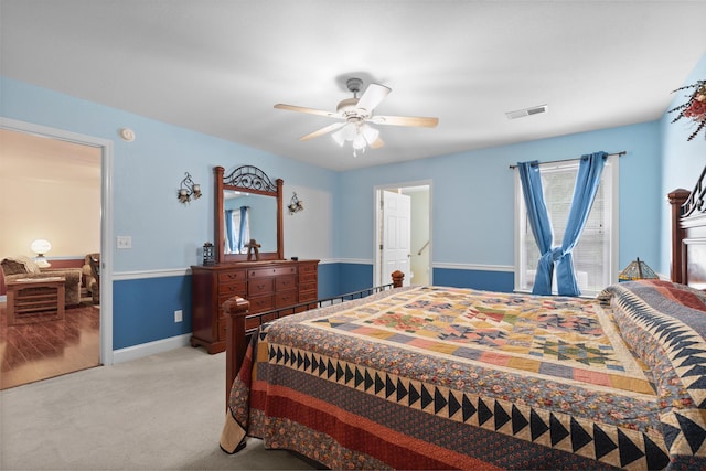 bedroom with light carpet, baseboards, and a ceiling fan
