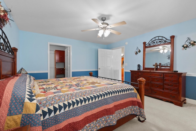 bedroom with light colored carpet, a ceiling fan, and baseboards