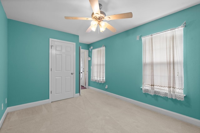 unfurnished bedroom with carpet, baseboards, and a ceiling fan