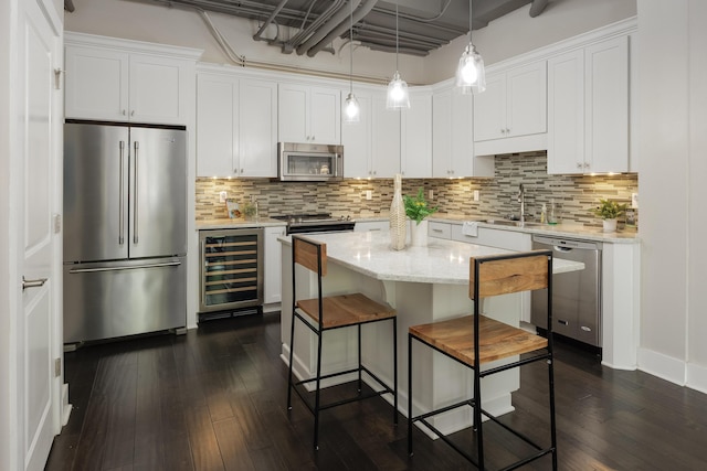 1301 Market St Unit 103, Chattanooga, TN 37402 - kitchen with stainless steel appliances, wine cooler, a sink, white cabinetry, and dark wood-style floors