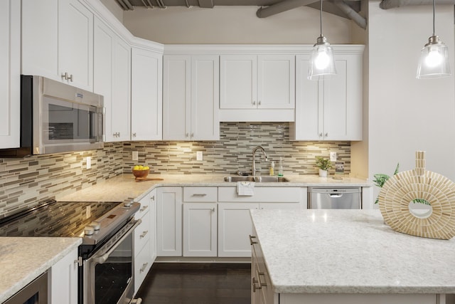 1301 Market St Unit 103, Chattanooga, TN 37402 - kitchen featuring stainless steel appliances, a sink, white cabinetry, and backsplash