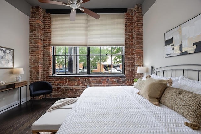 1301 Market St Unit 103, Chattanooga, TN 37402 - bedroom featuring wood-type flooring, multiple windows, and brick wall