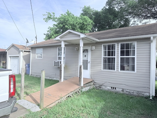 5518 Miller Dr, Chattanooga, TN 37411 - view of front of house featuring a front lawn, an outbuilding, a garage, and roof with shingles