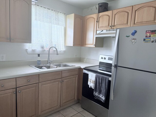 5518 Miller Dr, Chattanooga, TN 37411 - kitchen featuring appliances with stainless steel finishes, a sink, under cabinet range hood, light brown cabinetry, and light countertops