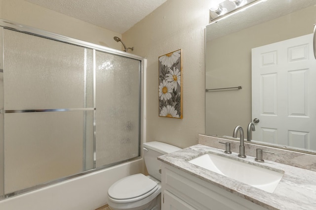full bathroom with a textured ceiling, toilet, vanity, enclosed tub / shower combo, and a textured wall