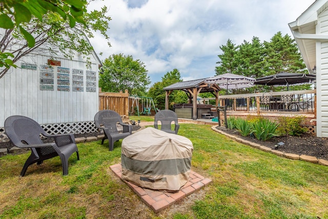 view of yard featuring a playground, a gazebo, and a deck