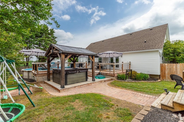 view of yard with a hot tub, a gazebo, and a deck