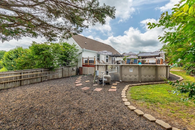 view of yard with fence and a wooden deck