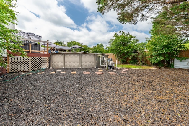 fenced backyard with a wooden deck