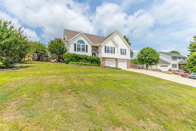 split foyer home featuring concrete driveway, an attached garage, brick siding, and a front yard