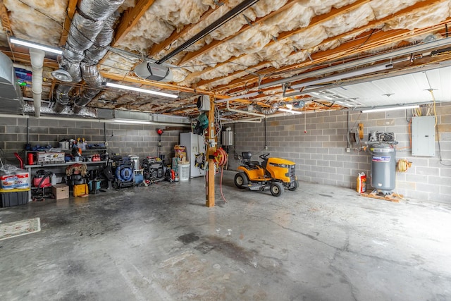 garage with electric panel, a garage door opener, and concrete block wall