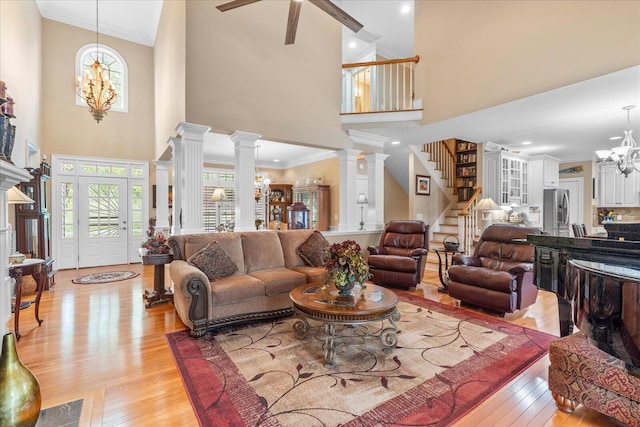 362 Windmill Ln, Georgetown, TN 37336 - living area featuring a chandelier, light wood finished floors, stairs, a towering ceiling, and crown molding