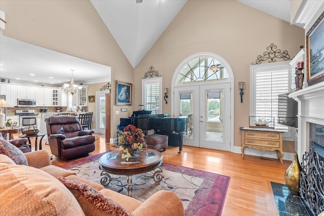 362 Windmill Ln, Georgetown, TN 37336 - living area with a tiled fireplace, a chandelier, light wood-style flooring, high vaulted ceiling, and recessed lighting